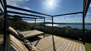 An outdoor seating area with a view of a body of water and hills. - Apartment in siavonga (Siavonga)