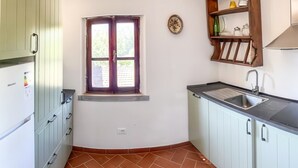 A compact kitchen with a window, a sink, and a built-in cabinet. - Tenuta San Lorenzo - Relax Among Vineyards and Olive Groves (Monte san savino)