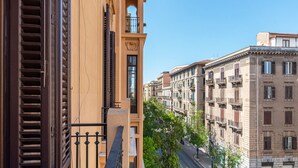 A multi-story building with balconies and a street view. - Roma 1923 - Casa Rossa by Wonderful Italy (Palermo)