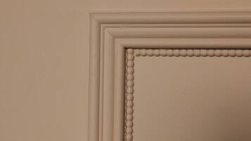 A wall with a decorative molding and a recessed panel.