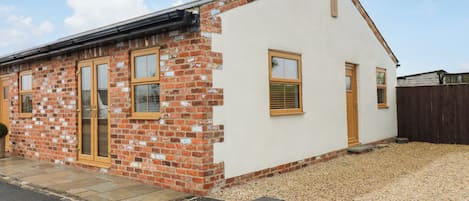 A single-story house with a brick facade and white exterior walls.