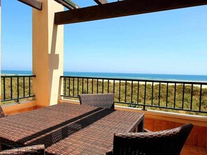 A balcony with a view of the ocean, wicker furniture, and a railing. - Los Pelícanos - Facing the sea, pool and garden - Ref.411F (Punta del Moral)