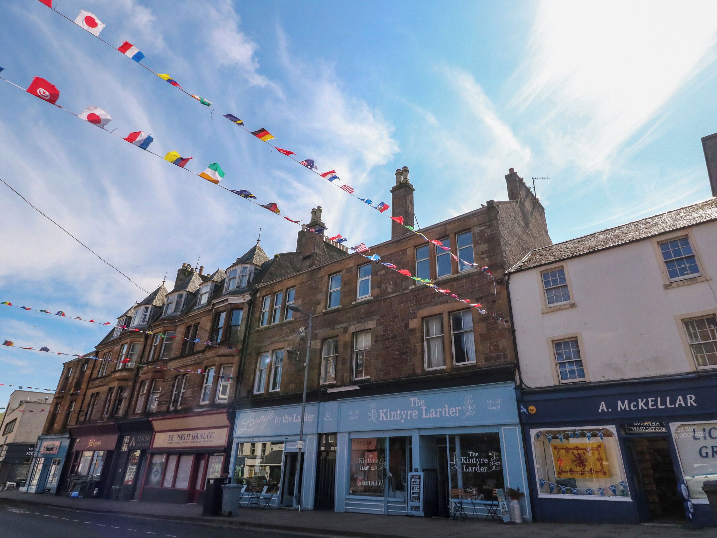 A street view with a row of shops, including 'The Kintyre Larder' and 'A. McKellar'.