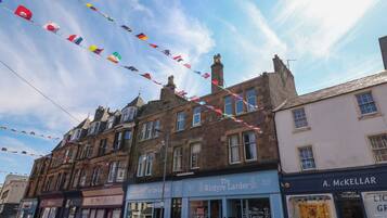 A street view with a row of shops, including 'The Kintyre Larder' and 'A. McKellar'.