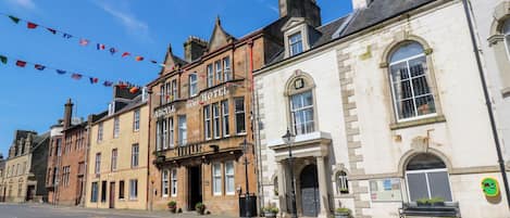A historic building with a prominent sign for 'Argyll Arms Hotel' and a traditional stone facade.