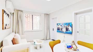 Comfort Suite | Living area | 50-inch flat-screen TV with cable channels