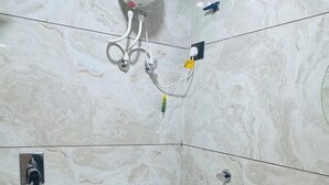 A bathroom with a toilet, bidet, and a sink. - Hotel sun town (Ahmedabad)
