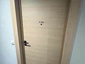 A wooden door with a label 'A 305' and a door handle. - Apartment with parking - 6 guests (Arâches-la-Frasse)