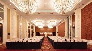 A conference room with rows of tables, chairs, and a red carpeted floor. - Zhongjian Xingfu Hotel (Hankou Railway Station Branch), Wuhan (Wuhan)