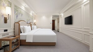 A hotel room with a large bed, bedside tables, a TV, and a wall with a floral mural. - Zhongjian Xingfu Hotel (Hankou Railway Station Branch), Wuhan (Wuhan)