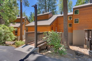 A wooden cabin with a deck and a staircase leading to the entrance. - Alpine Retreat: 3  BR, 2  BA Condominium in Tahoe City, Sleeps 10 (Tahoe City)