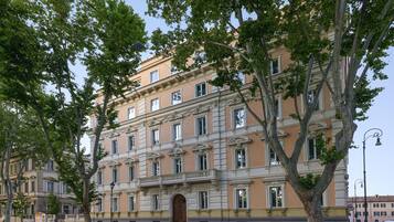 Un edificio a più piani con architettura classica, caratterizzato da un ingresso centrale con una grande porta e numerose finestre.