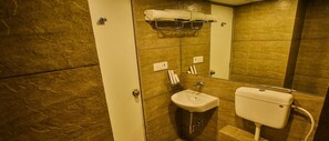 A bathroom with a toilet, sink, and towel rack.