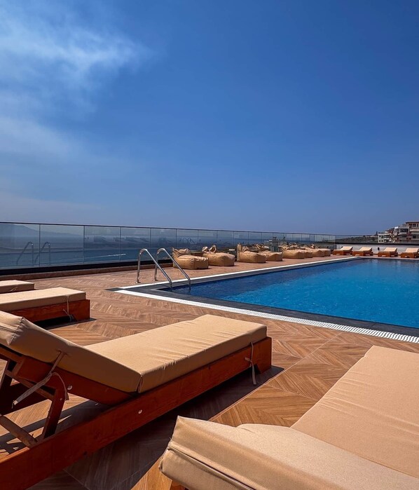 A rooftop pool with lounge chairs and a glass barrier. - "Onyx" – Adults Only (+16) (Saranda)