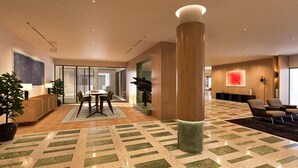 A spacious lobby with a large central column, a reception desk, and a seating area with chairs. - Nishat Hotel Margala (Islamabad)