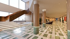 A spacious lobby with a staircase, large pillars, and a patterned floor. - Nishat Hotel Margala (Islamabad)