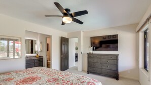 A bedroom with a bed, a dresser, a ceiling fan, a TV, and a door leading to another room. - 2 Mi to Lake Havasu! Mtn-view Poolside Paradise (Lake Havasu City)