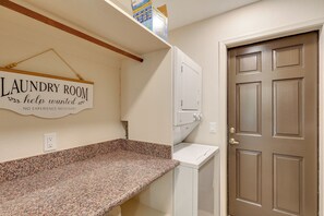 A laundry room with a sign, a countertop, a washing machine, and a door. - 2 Mi to Lake Havasu! Mtn-view Poolside Paradise (Lake Havasu City)