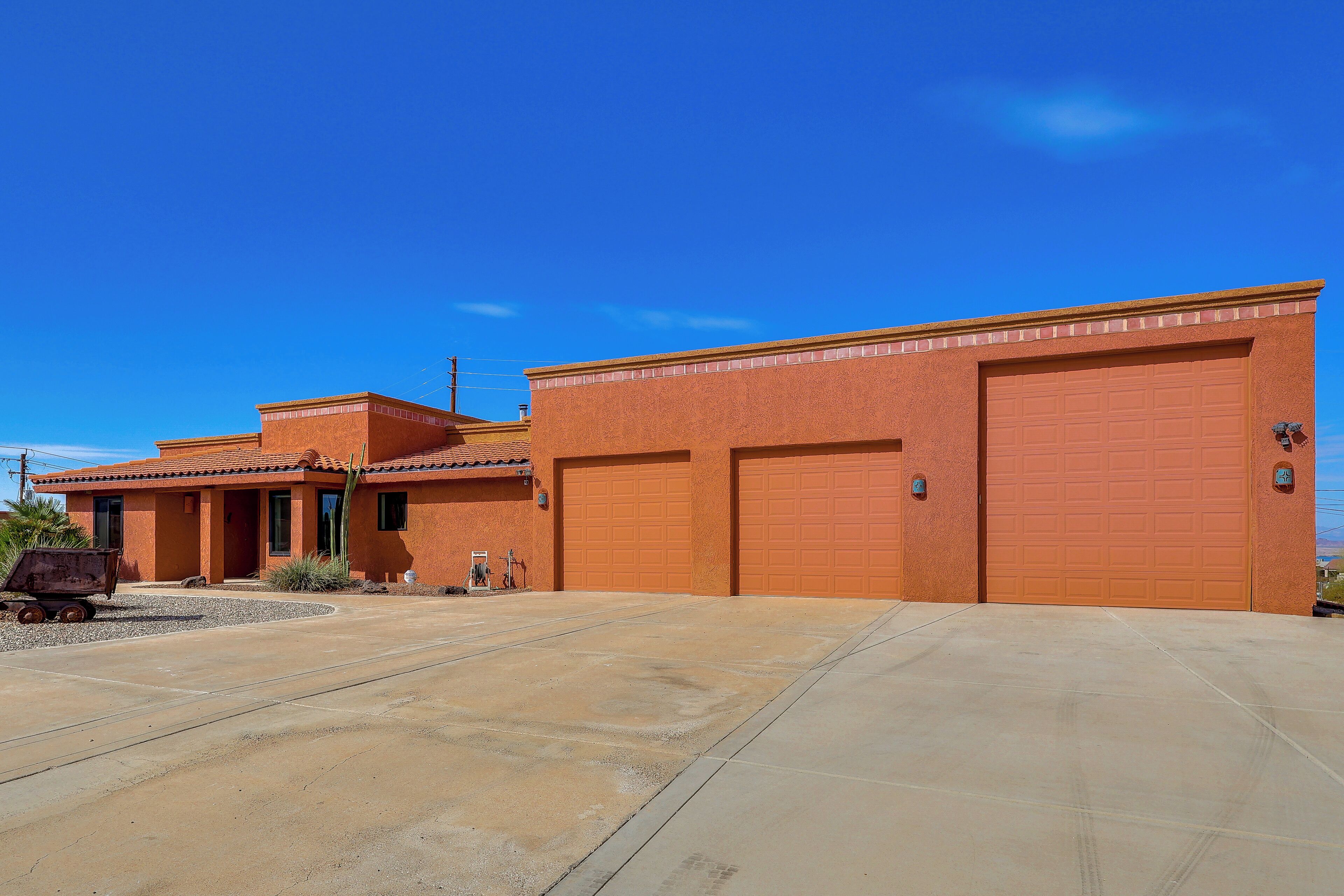 A two-story building with a garage and a driveway.