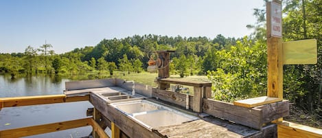 A wooden deck with a sink and a sign prohibiting swimming.