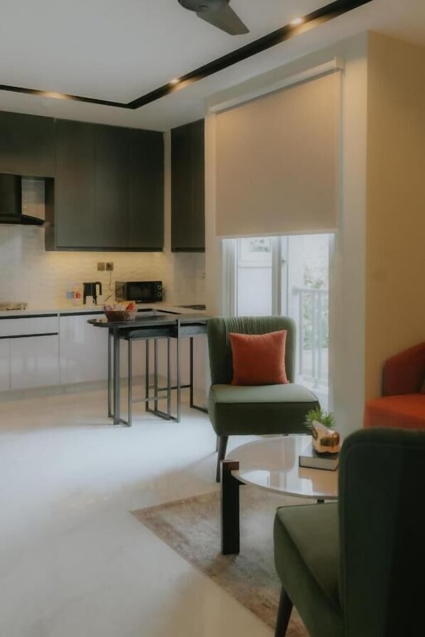Apartment, 1 King Bed | Living area | 42-inch LED TV with satellite channels - Address 12 Apartments Model Town Lahore (Lahore)