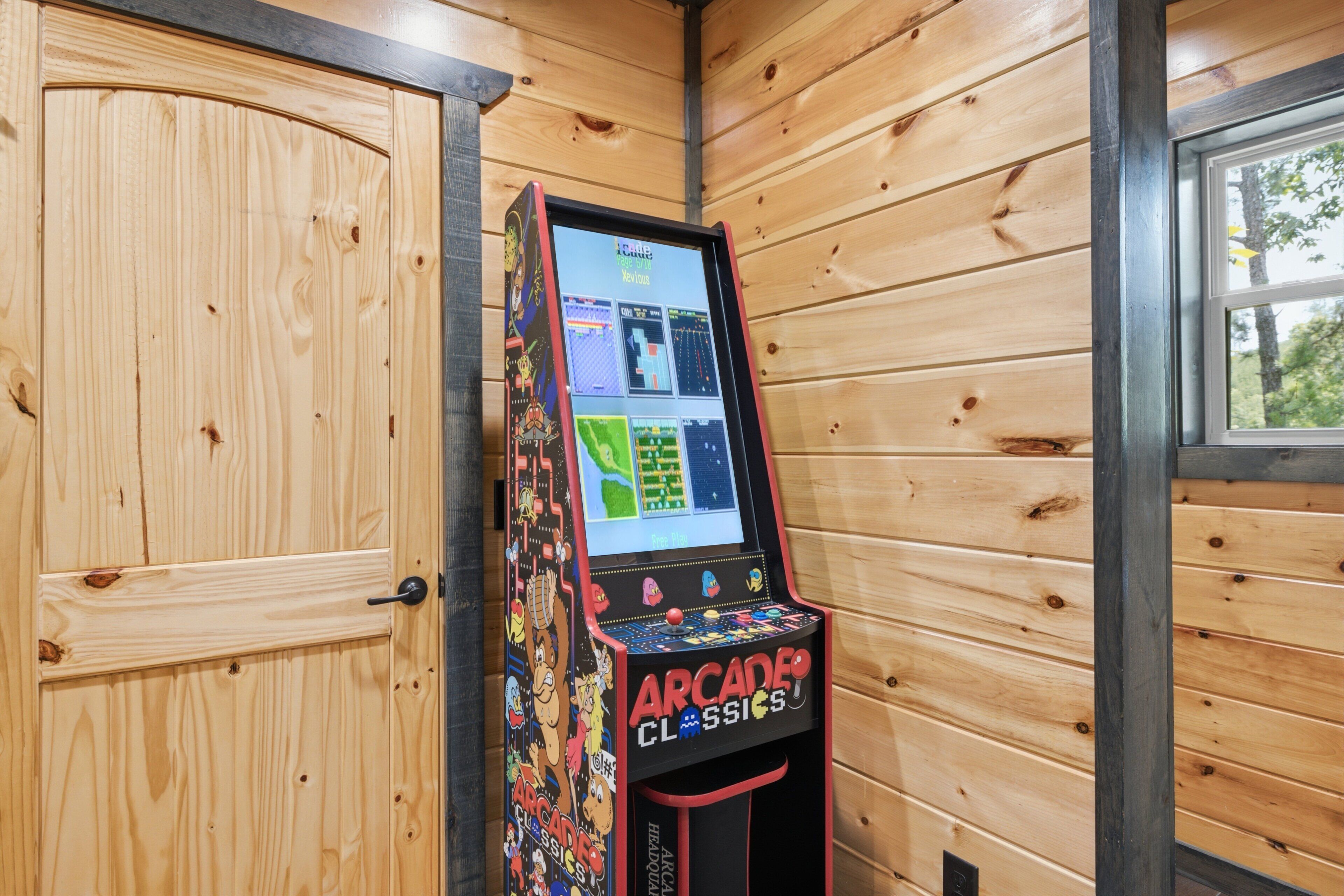 A wooden-paneled room with a retro arcade machine labeled 'Arcade Classics' and a door.