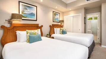 A hotel room with two beds, a large window, and a door leading to a bathroom.