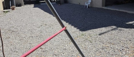 A gravel driveway leading to a building with a garage.