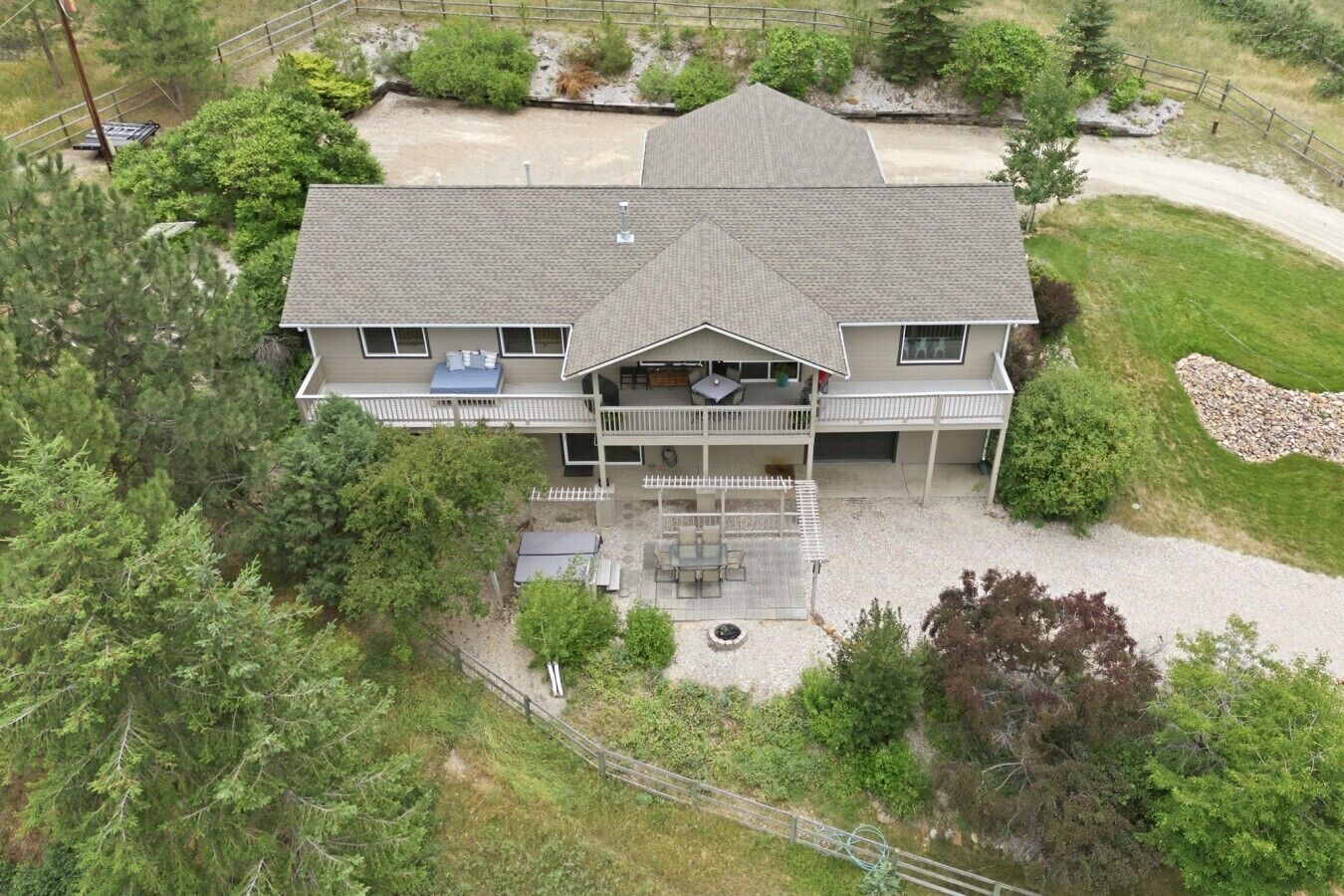 A two-story house with a covered porch and a fenced yard.