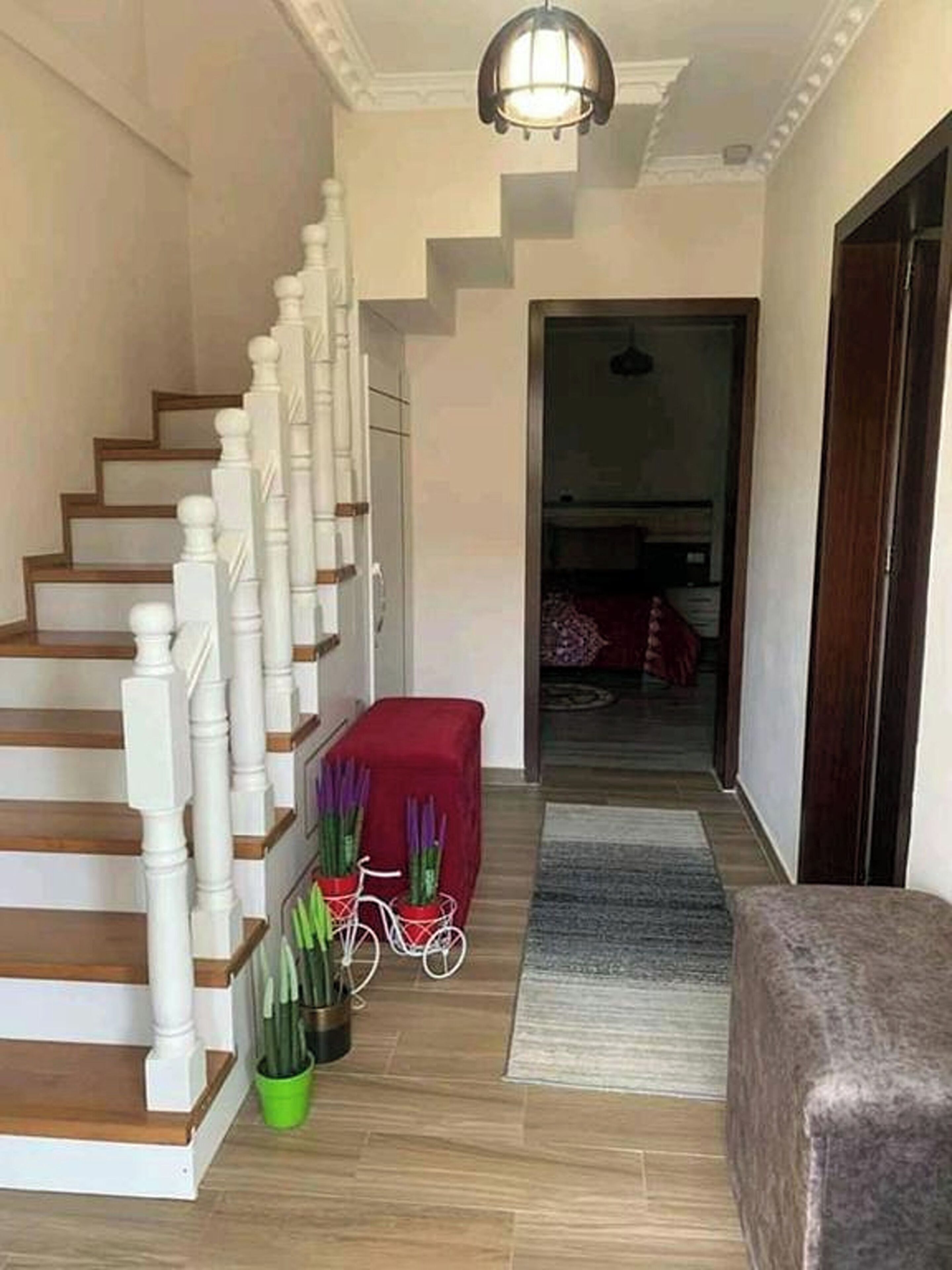 A staircase with white balusters and wooden steps leading to a landing.