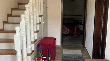 A staircase with white balusters and wooden steps leading to a landing.