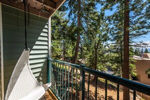 A hammock on a balcony with a view of a forest and a building in the background. - Quiet Tahoe Retreat • Near Heavenly & Hiking (Stateline)