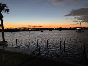 A waterfront view with a dock and boats. - Luxury Waterfront Condo in Coquina Key w/ Breathtaking Views - gated community. (St. Petersburg)
