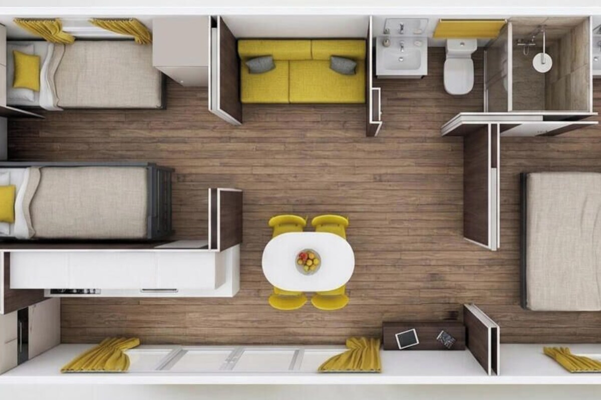 A hotel room layout with a bed, a sofa, a dining table, and a bathroom.