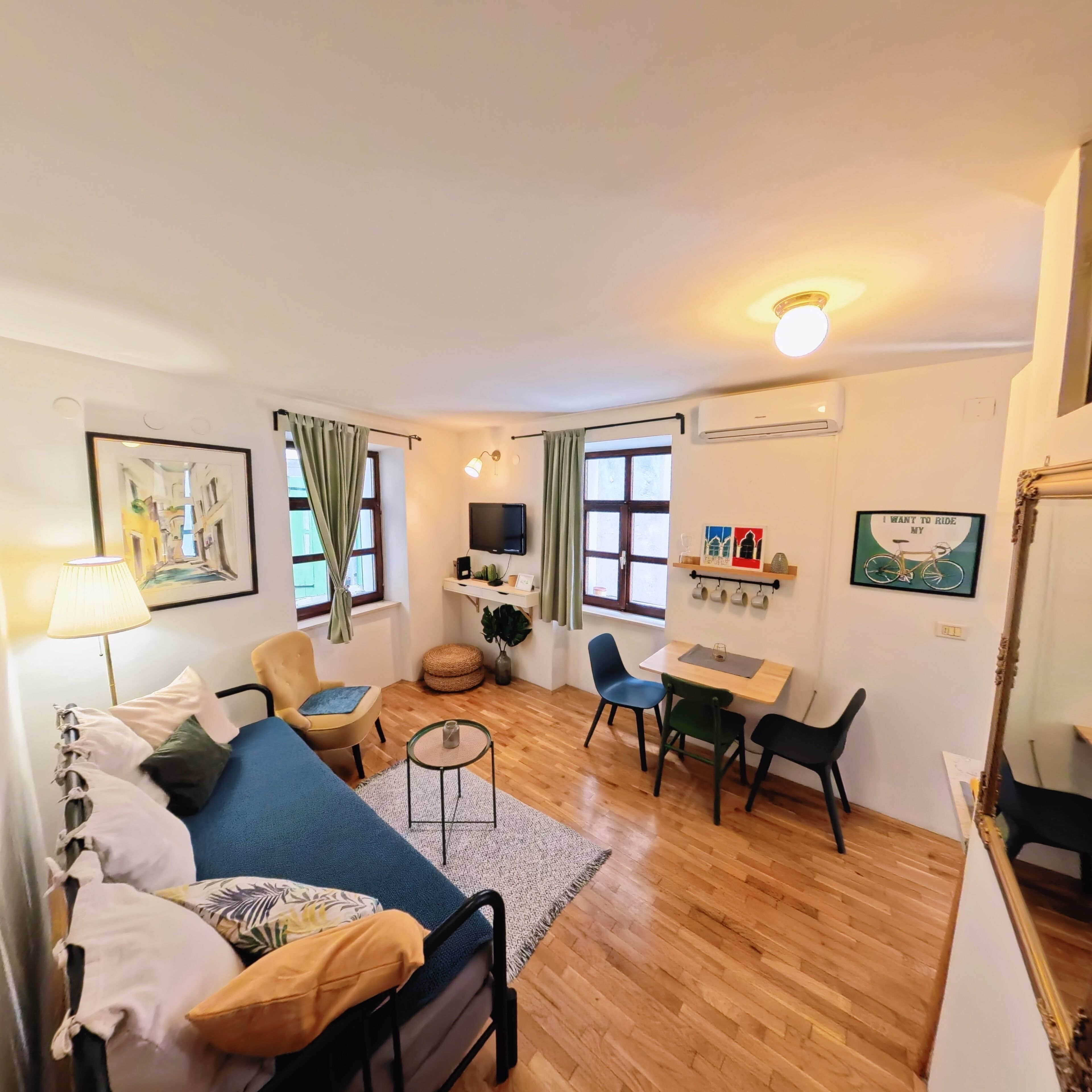 A compact living space with a sofa, a small table, and a TV.