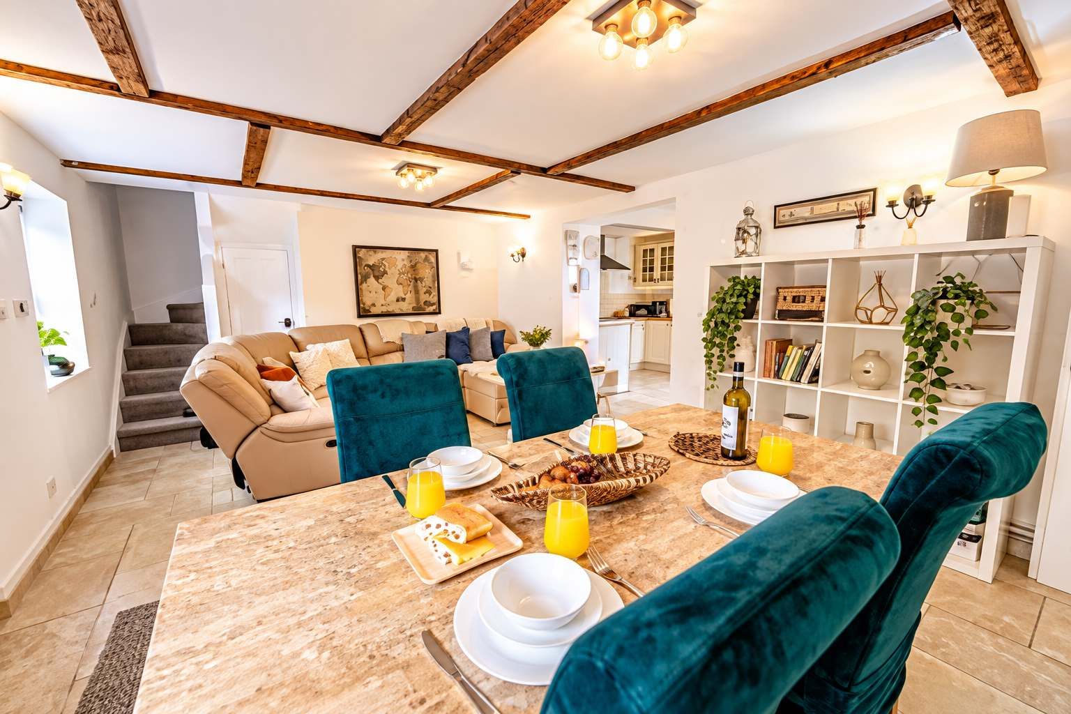 Dining Area : Dining table with seating for guests, shelves with decor, and wine bottle , set the stage for memorable group meals and morning coffee.