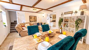 Dining Area : Dining table with seating for guests, shelves with decor, and wine bottle , set the stage for memorable group meals and morning coffee.