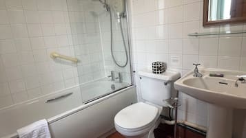A bathroom with a glass-enclosed shower, a toilet, and a sink.