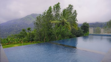 A swimming pool with a view of a mountainous landscape.
