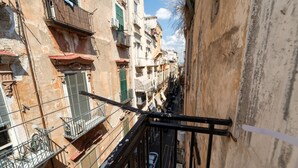 A narrow urban street with closely packed buildings, balconies, and a pedestrian walkway. - Appartamento in Piazzetta by Wonderful Italy (Naples)