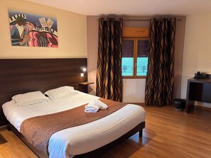 A hotel room with a bed, a nightstand, a telephone, a window with curtains, and a painting on the wall. - LA TOUR DES LYS (Mairieux)