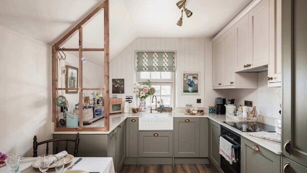 A kitchen with a wooden-framed window, a sink, and cabinets. - Stylish Sydney Wharf | Free Parking | Sleeps 4 (Bath)