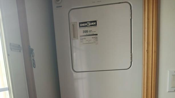 A compact, white, single-door refrigerator with an ENERGY GUIDE label indicating 398 kWh. - Two-Bedroom One-Bathroom Vacation Home - Pet Friendly! (Hunts Point)