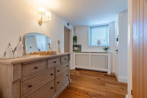 A room with a wooden dresser, a mirror, and a radiator. - The old School House Sleeps 16 (Barnoldswick)