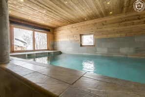 An indoor swimming pool with wooden ceiling and stone walls. - Apartment 'Le Sabot De Vénus - Chalet Le Névé' with Mountain View, Shared Terrace and Wi-Fi (Bonneval-sur-Arc)