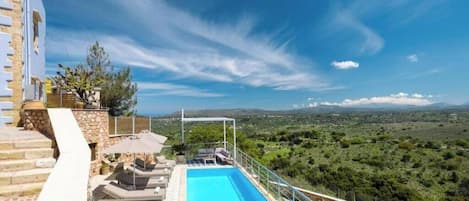 A rooftop pool with a clear view of the surrounding landscape.