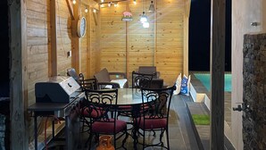 An outdoor dining area with a wooden ceiling, string lights, and a welcome sign. - Spacious 4-bedroom house in adorable Cabrera with AC and gym (Cabrera)