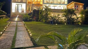 A modern two-story house with a well-lit entrance and a paved pathway leading to the door. - Spacious 4-bedroom house in adorable Cabrera with AC and gym (Cabrera)