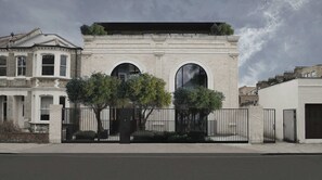 A modern building with two large arched windows and a flat roof. - The Westlight: Bright LG Studio in White City (London)