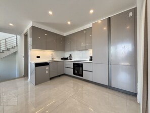 A modern kitchen with built-in appliances, a dishwasher, and a stainless steel refrigerator. - Elegant 5BR Villa | Private Pool (Bodrum)